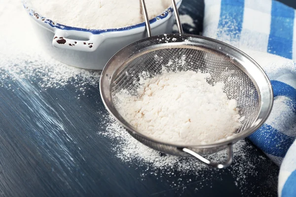 Sifting flour through sieve — Stock Photo, Image