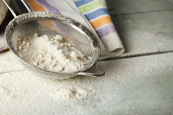 Sifting flour through sieve — Stock Photo, Image