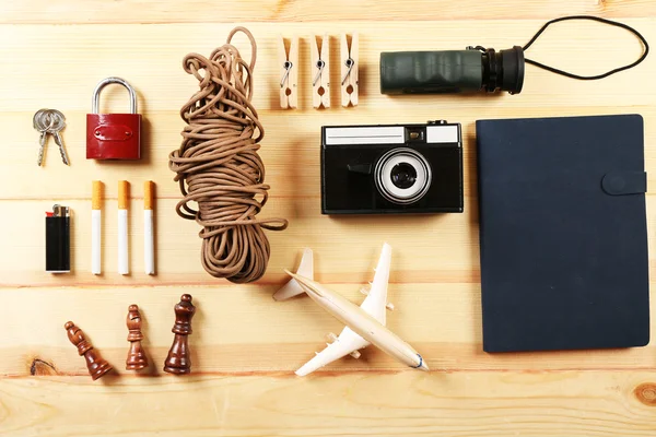 Travel gear on wooden table, top view