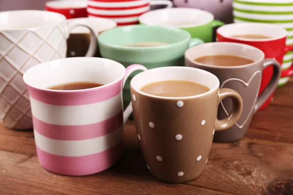 Cups of cappuccino on wooden table, closeup — Stock Photo, Image