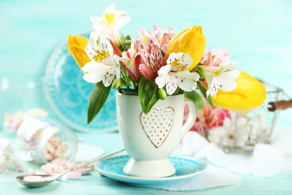 Beautiful flowers in cup — Stock Photo, Image