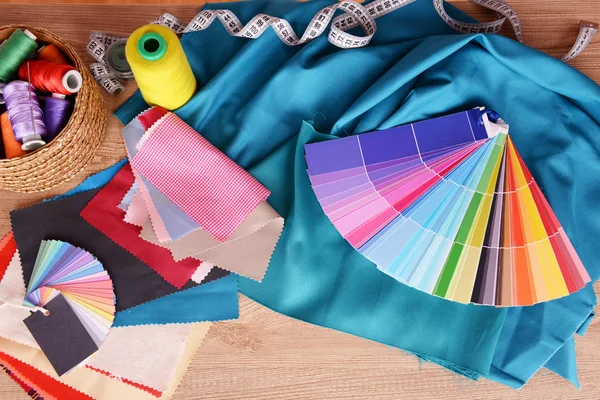 Samples of colorful fabric on wooden table, top view — Stock Photo, Image