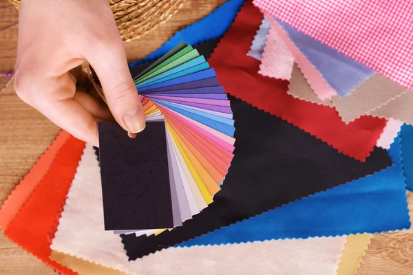 Samples of colorful fabric in female hand, closeup — Stock Photo, Image