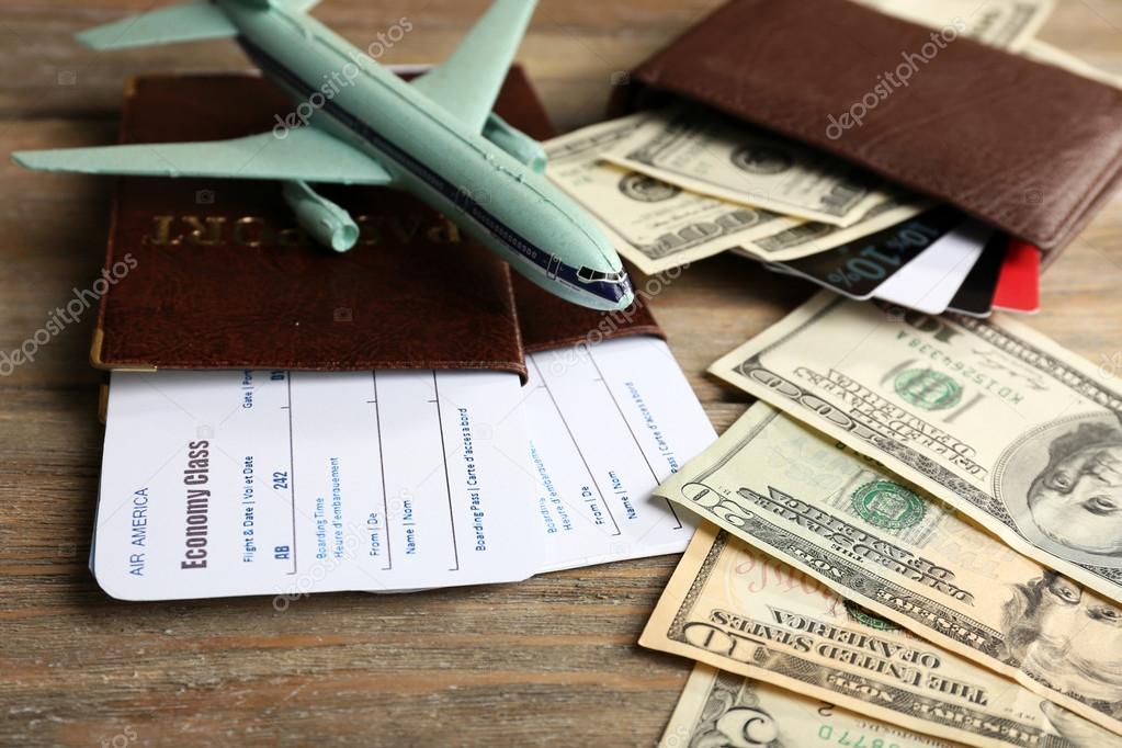 Airline tickets and documents on wooden table, closeup