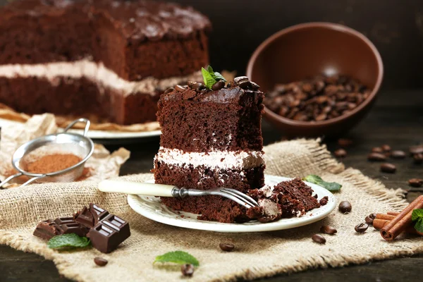 Delicious chocolate cake on table on brown background — Stock Photo, Image