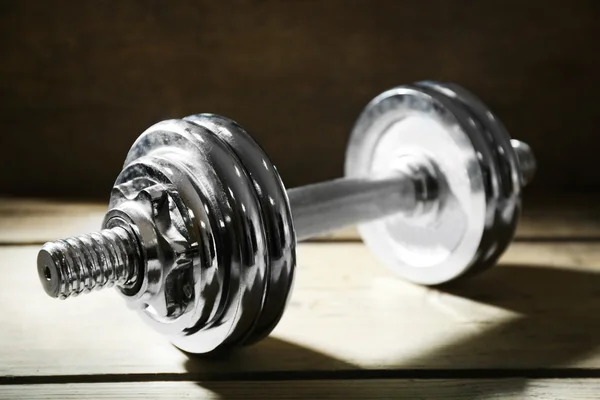 Big dumbbells on wooden background — Stock Photo, Image