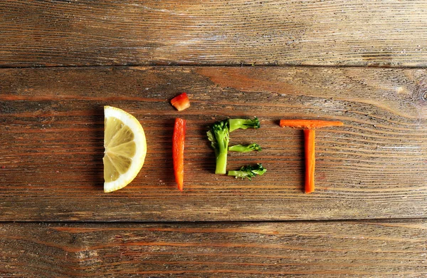 Word DIET made of sliced vegetables on wooden background — Stock Photo, Image