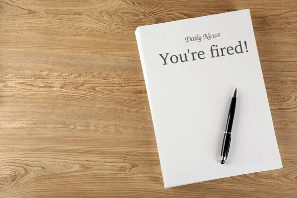 Message You're Fired on wooden table, top view — Stock Photo, Image