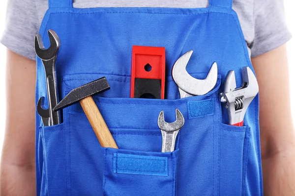 Man in overall met tools — Stockfoto
