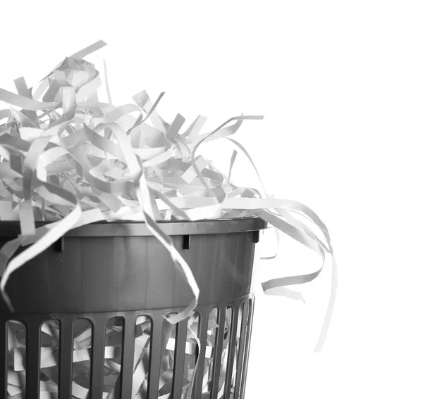 Strips of destroyed paper from shredder in trash can isolated on white — Stock Photo, Image