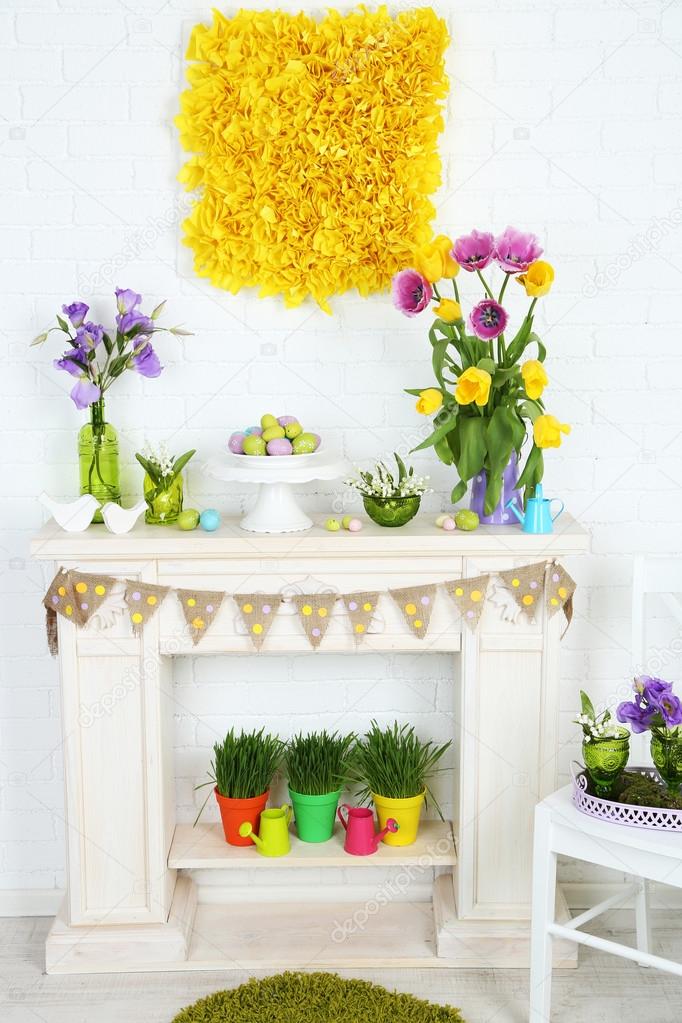 Fireplace With Beautiful Spring Decorations In Room Stock Photo