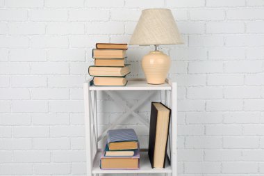 kitap ve lamba ile ahşap raf
