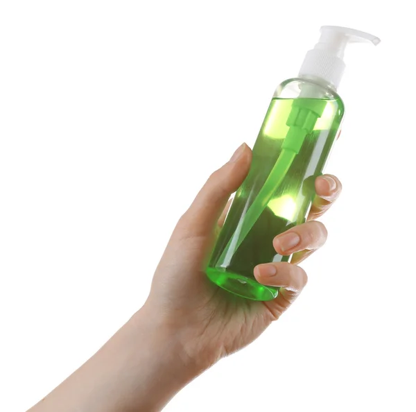 Vrouwelijke handen met cosmetica fles — Stockfoto