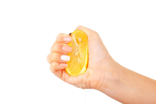 Female hand squeezing lemon isolated on white — Stock Photo, Image