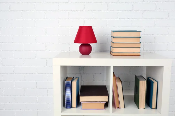 Wooden shelf with books and lamp — Stock Photo, Image