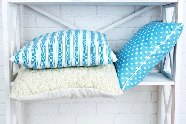 Decorative pillows on shelf — Stock Photo, Image