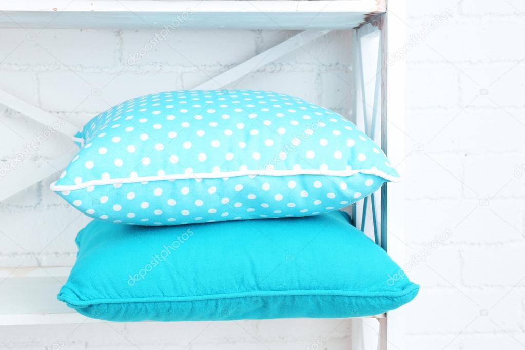 Decorative pillows on shelf