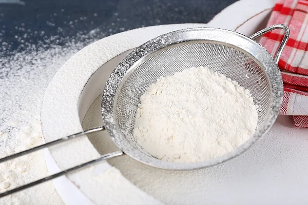 Sifting flour through sieve — Stock Photo, Image