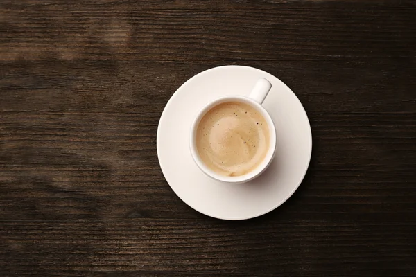 Cup of coffee on wooden table — Stock Photo, Image