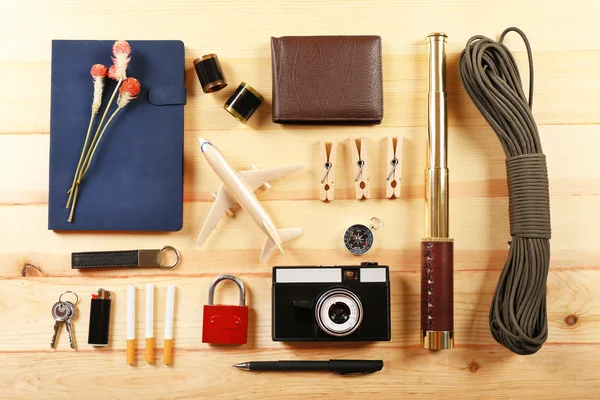 Travel gear on wooden table, top view — Stock Photo, Image
