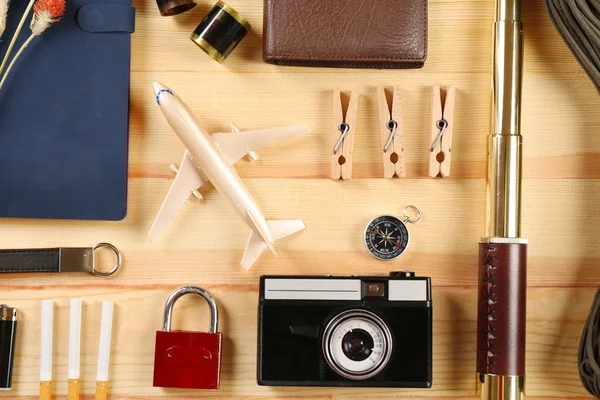 Travel gear on wooden table, top view — Stock Photo, Image