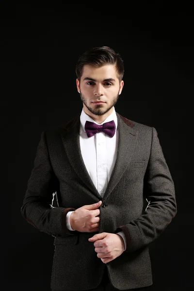 Elegant man in suit on dark background — Stock Photo, Image