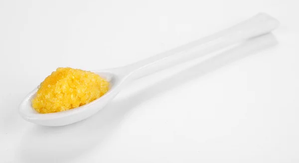 Laboratory spatula with granules — Stock Photo, Image