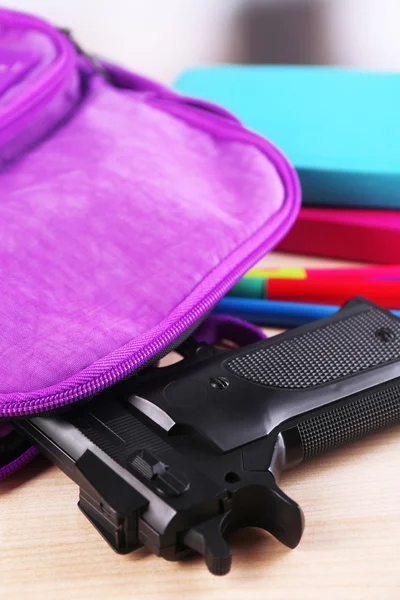 Gun in school backpack — Stock Photo, Image