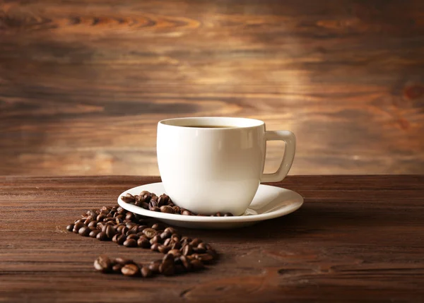 Cup of coffee with grains — Stock Photo, Image