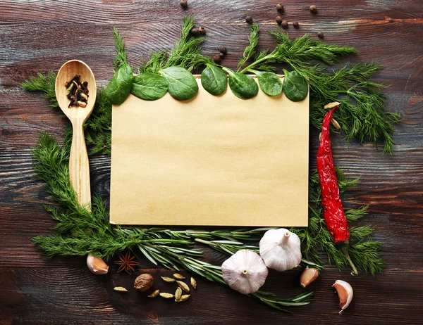 Open recipe book with fresh herbs and spices — Stock Photo, Image
