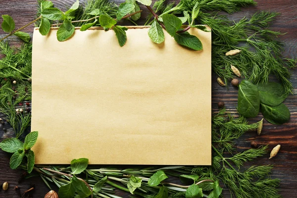 Open recipe book with fresh herbs and spices