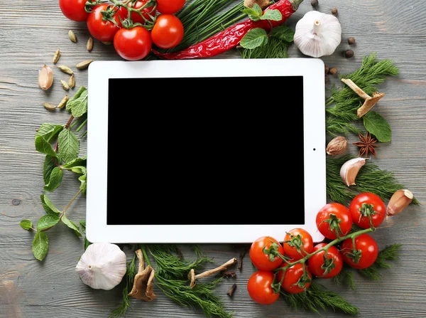 Digital tablet with fresh herbs — Stock Photo, Image