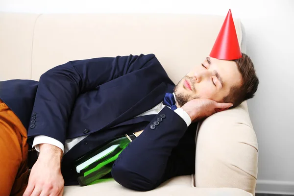 Young man on couch after fun close up — Stock Photo, Image