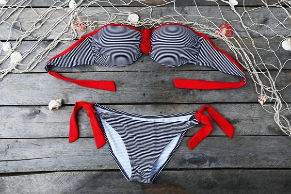 Swimsuit on wooden background — Stock Photo, Image