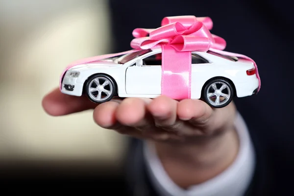 Man holding model of car in his hands, closeup — Stock Photo, Image