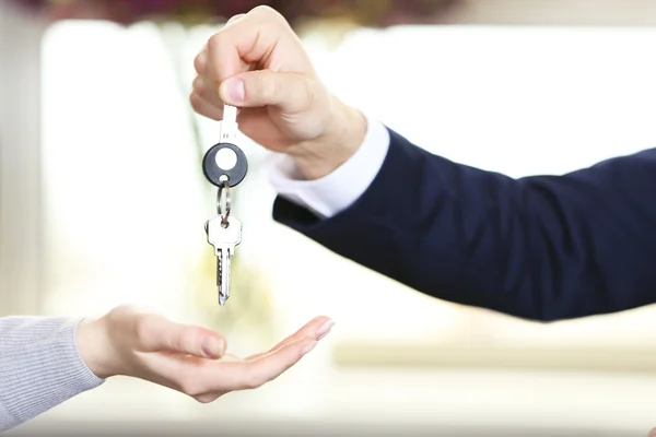 Hand of businessman giving keys to female hand Royalty Free Stock Photos