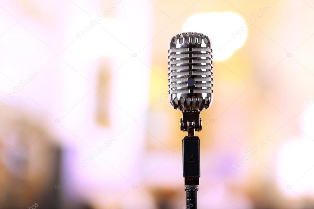 Retro microphone on blurred background