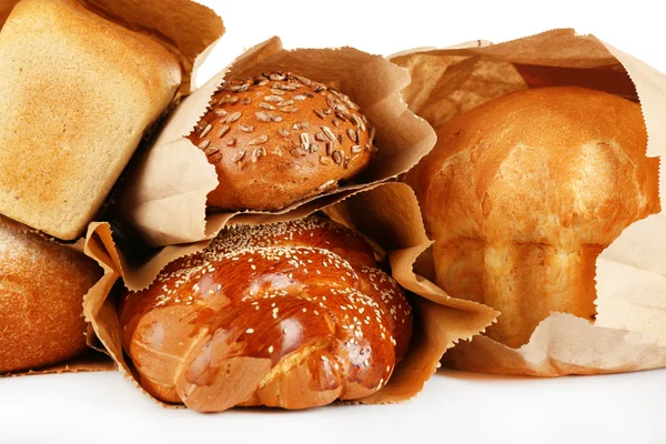 Fresh bread in paper bags on white background — Stock Photo, Image