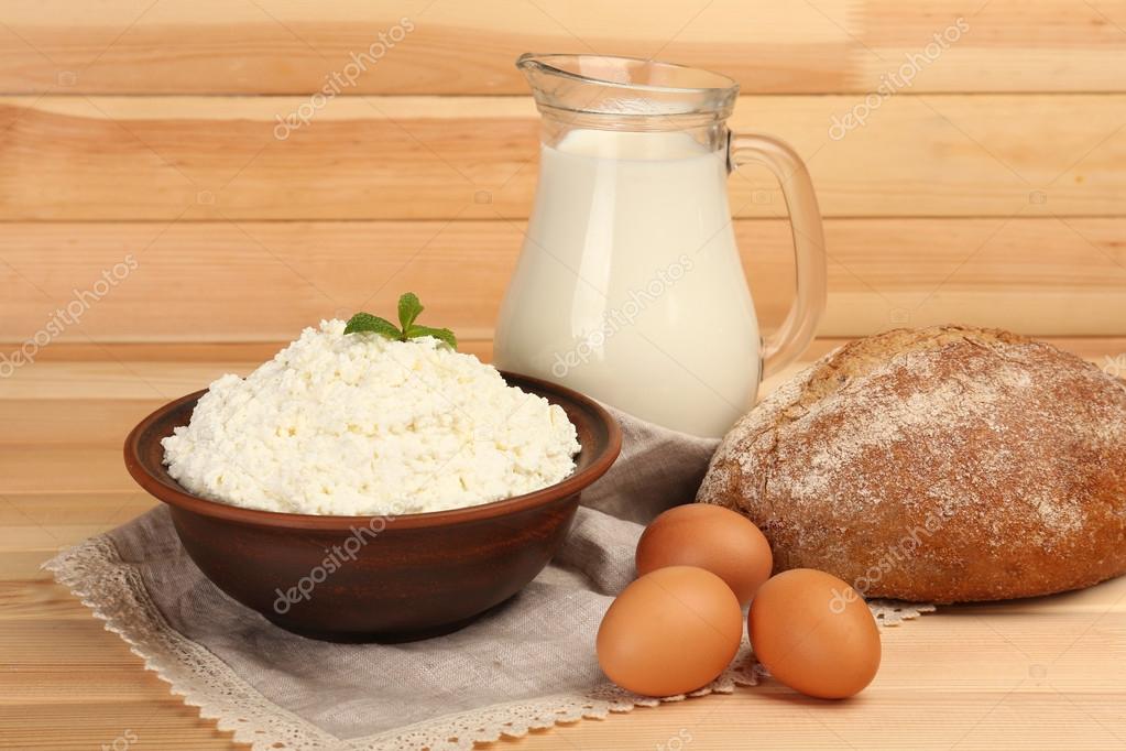 Cottage Cheese In Clay Bowl With Jug Of Milk Eggs And Loaf Of