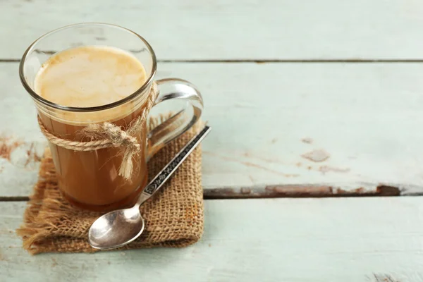 Glass cup of cocoa on color wooden planks background — Stock Photo, Image