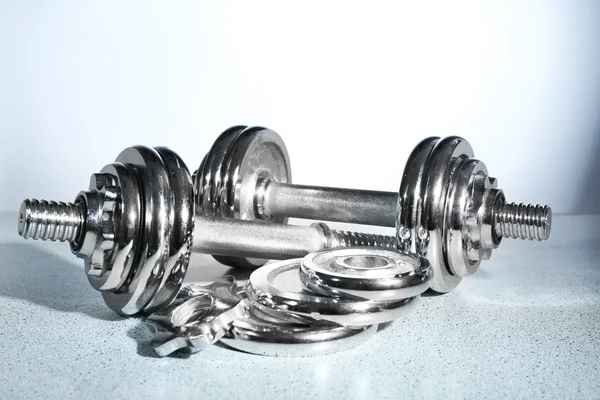 Dumbbells on gray background — Stock Photo, Image