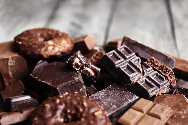 Set of chocolate on wooden table, closeup — Stock Photo, Image