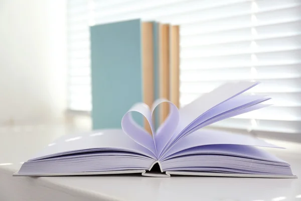 Books on white windowsill, close up — Stock Photo, Image