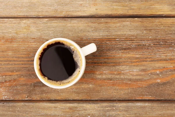 Cup of coffee on wooden table, top view — Stock Photo, Image