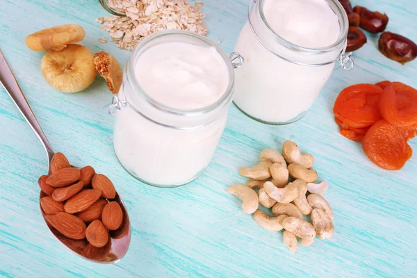 Healthy breakfast with dried fruits and nuts on color wooden background — Stock Photo, Image