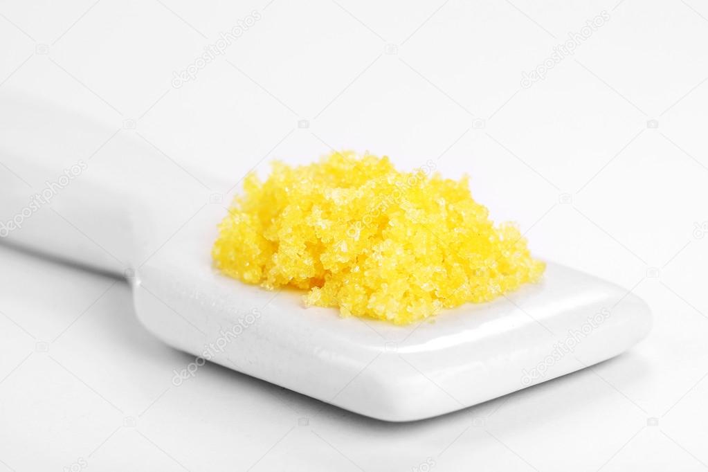 Laboratory spatula with granules isolated on white