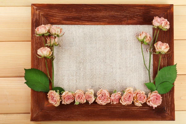 Frame of beautiful dry flowers with frame on wooden background — Stock Photo, Image