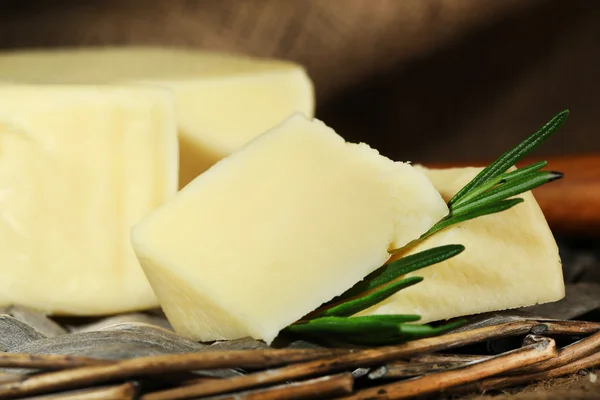 Cheese on wicker tray — Stock Photo, Image