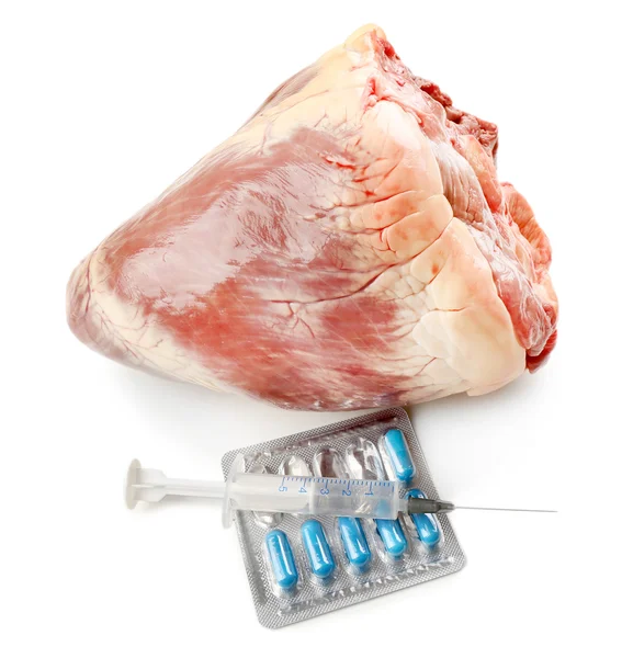 Raw animal heart with syringe and tablets isolated on white — Stock Photo, Image