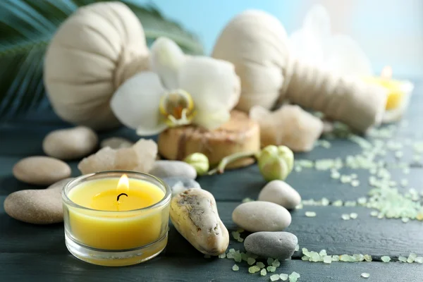 Still life with beautiful blooming orchid flower, spa treatment on wooden table, on bright background — Stock Photo, Image